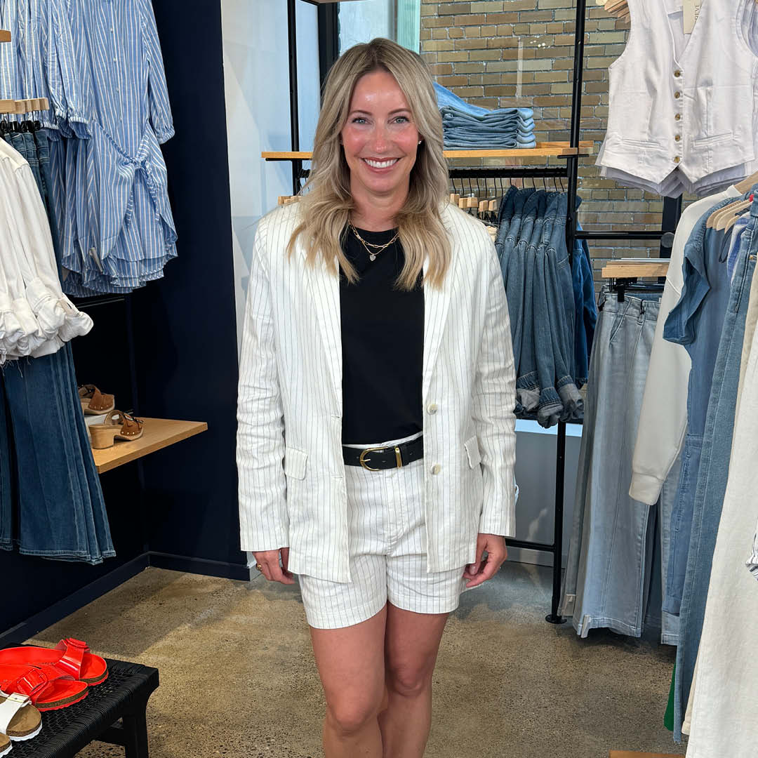 Heidi wearing matching white blazer set