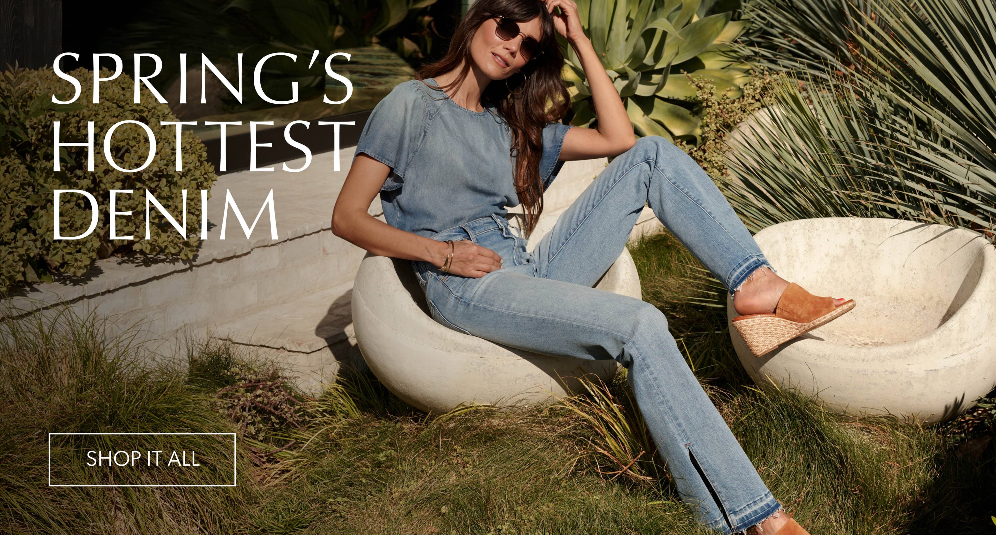 Woman with long brown hair wears a chambray shirt with blue jeans, sandals and sunglasses. - Shop Now